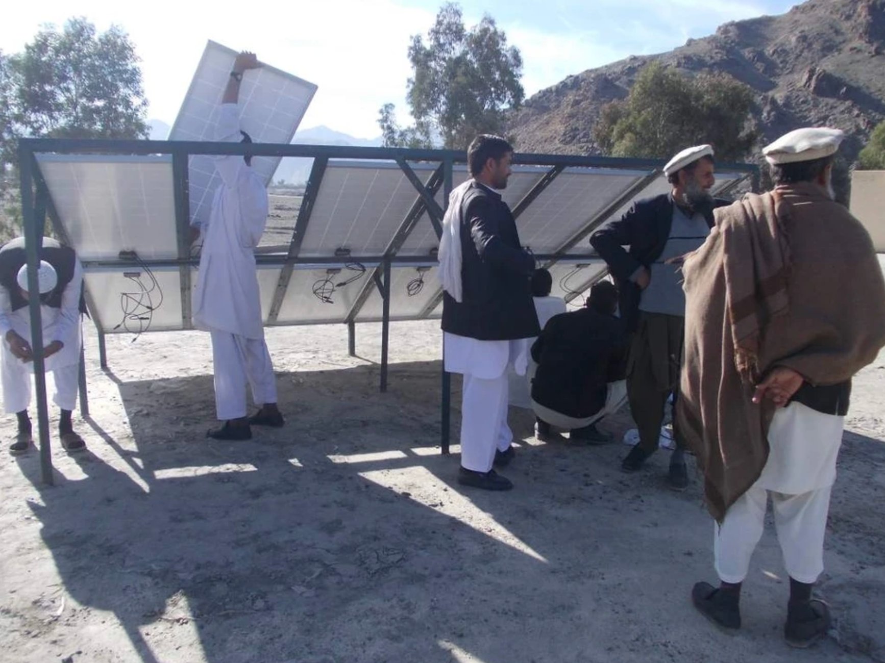 Community members installing solar panels